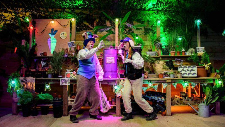 An image of two actors, dressed as Easter bunnies, performing on stage.