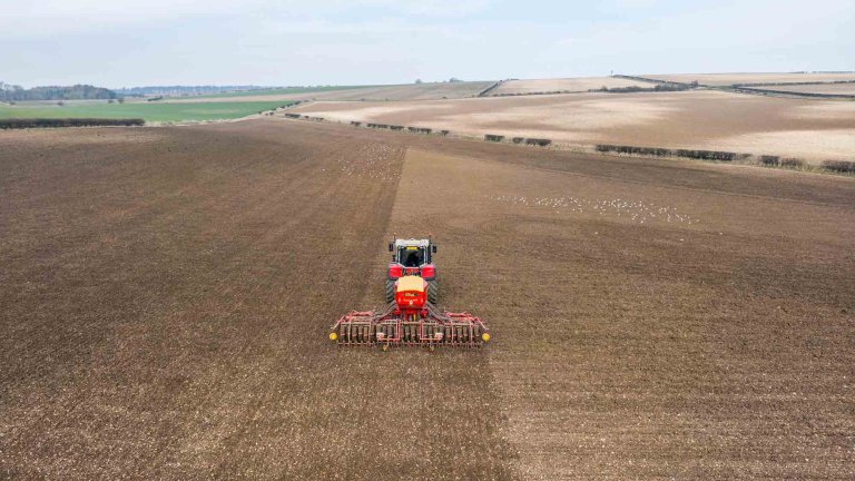 An aerial image of a tractor working in a field.