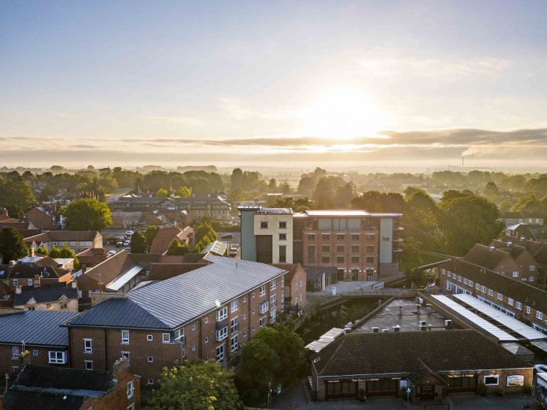 An images, taken from a drone, of the Hub in Sleaford, Lincolnshire. The picture was taken as the sun was rising on a summer day giving the image a picturesque feel.