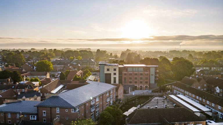 An images, taken from a drone, of the Hub in Sleaford, Lincolnshire. The picture was taken as the sun was rising on a summer day giving the image a picturesque feel.