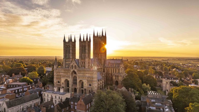 An aerial image of Lincoln Cathedral at sunrise.