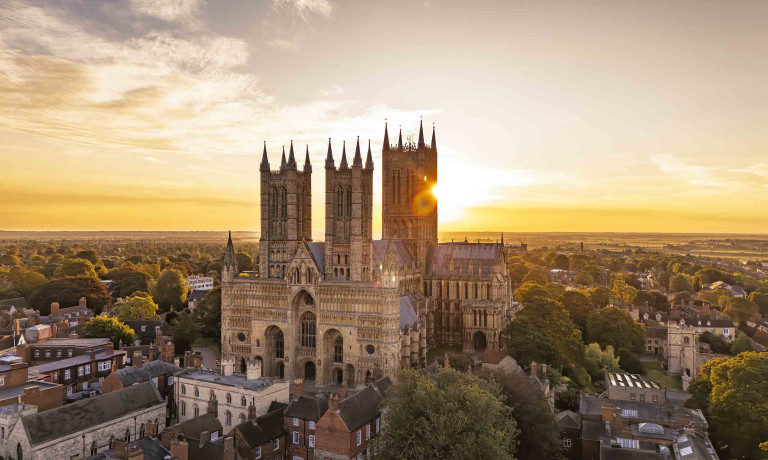 An aerial image of Lincoln Cathedral at sunrise.