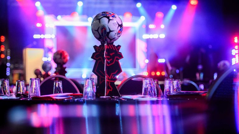 Table decorations set up ahead of a corporate awards event.