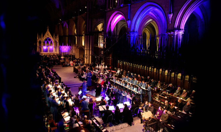 An image of a orchestra and Lincoln Cathedral choir performing in the Cathedral.