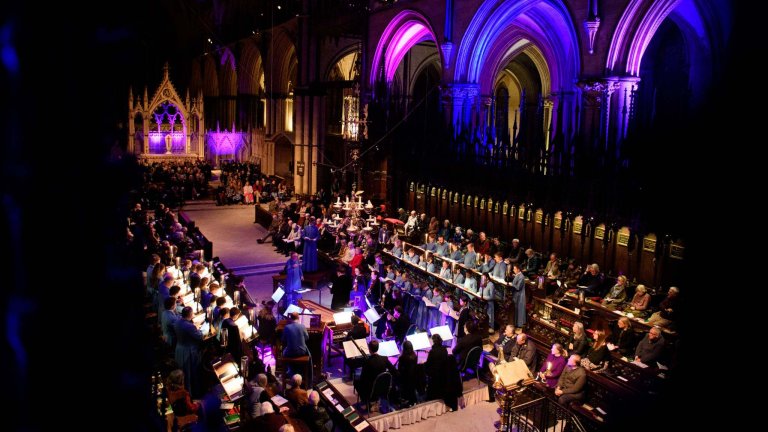 An image of a orchestra and Lincoln Cathedral choir performing in the Cathedral.