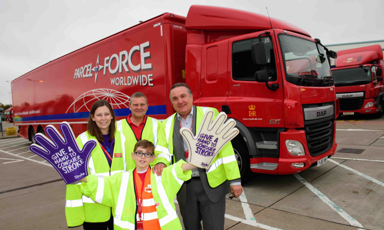 Chris Vaughan Photography - PR and communications images | A youngster holds giant foam hands to promote his charity fundraising adventure.