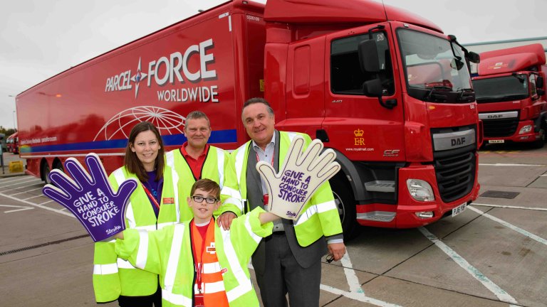 Chris Vaughan Photography - PR and communications images | A youngster holds giant foam hands to promote his charity fundraising adventure.