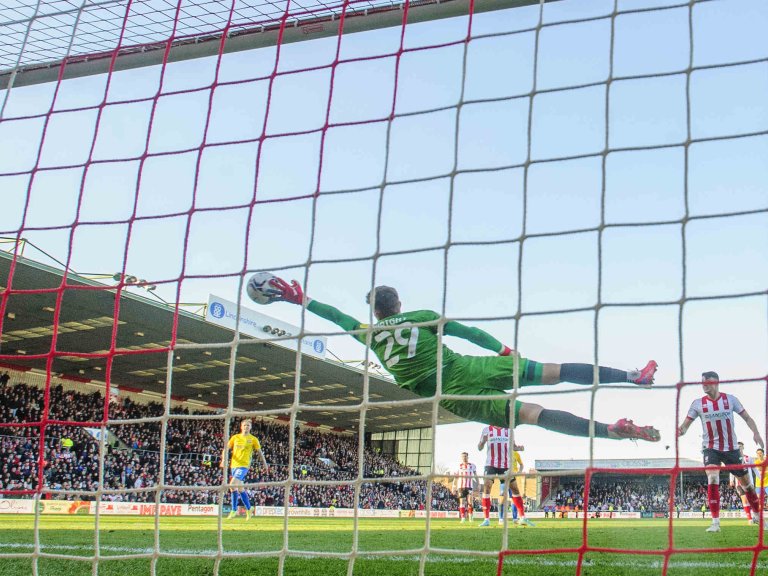 Chris Vaughan Photography - Sports images | Lincoln City goalkeeper Jordan Wright makes a full-length diving save.
