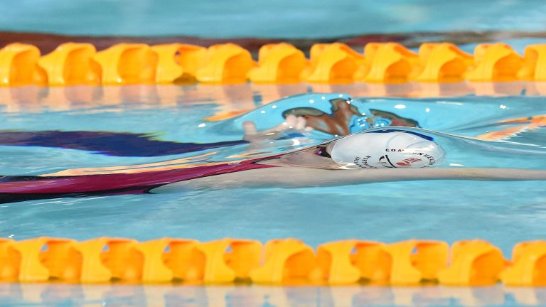 Chris Vaughan Photography - Sports images | A swimmer seen beneath the water before she breaks through the surface.