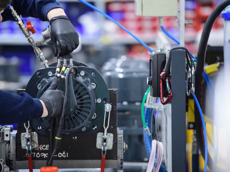 A close up of a Lancereal member of staff working on equipment.