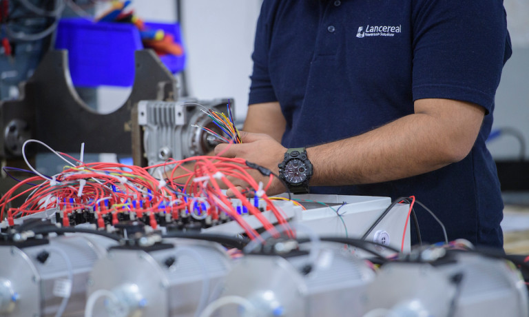 A close up of a Lancereal member of staff working on equipment.
