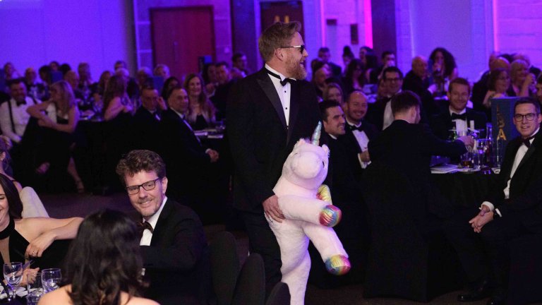 One of the hosts arrives to the event on a cuddly unicorn teddy.