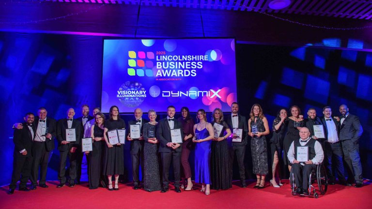 A group shot of all the winners and the event hosts on stage at the end of the evening.