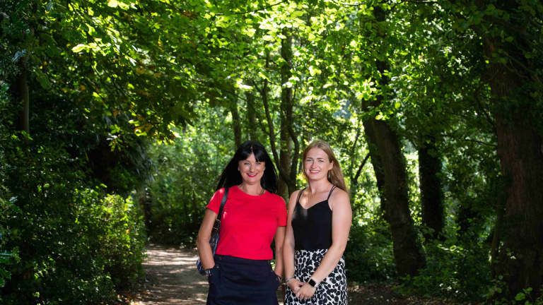 Chris Vaughan Photography - business profile photography | Two businesswomen stand framed by trees.