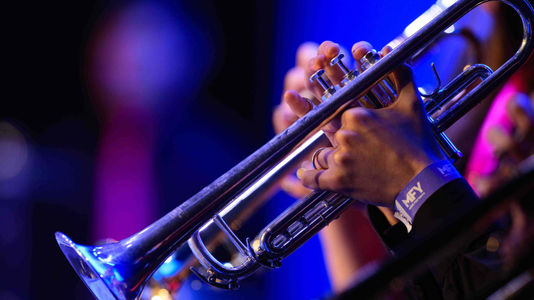 Chris Vaughan Photography - Commercial images | A close up on a person playing a brass musical instrument.