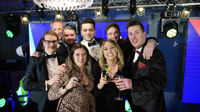 Chris Vaughan Photography - Corporate event images | A team of business people hold and award won at a corporate awards event.