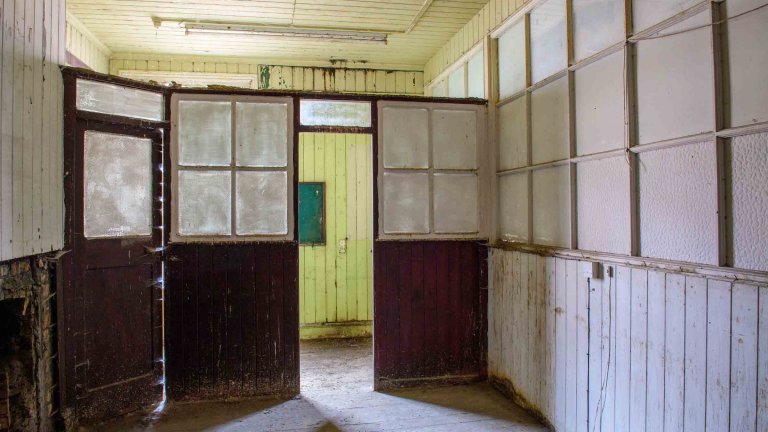 Interior of Building 89 showing glazed timber partitions and connecting rooms.