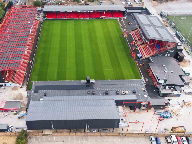 An aerial/drone photograph showing construction progress at the Imps Territory redevelopment.
