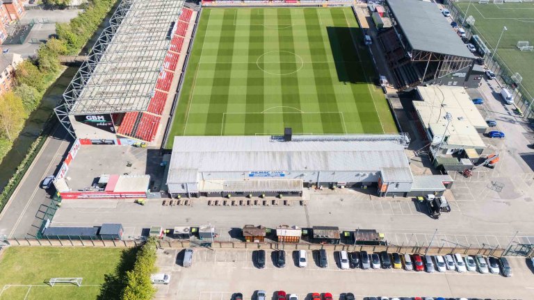 An aerial/drone photograph showing construction progress at the Imps Territory redevelopment.
