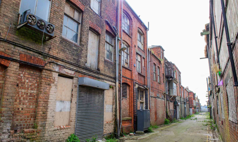Narrow dockside street between historic red-brick buildings in Grimsby&rsquo;s Kasbah.