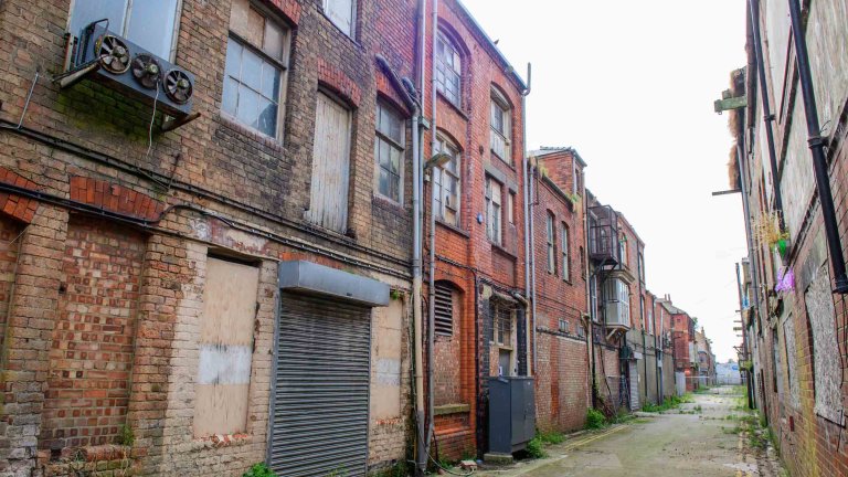 Narrow dockside street between historic red-brick buildings in Grimsby&rsquo;s Kasbah.