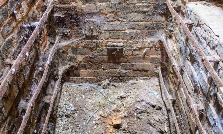 Brick-lined smoking chamber inside Peterson&rsquo;s Smokehouse before restoration.