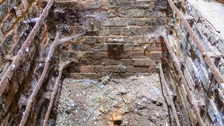 Brick-lined smoking chamber inside Peterson&rsquo;s Smokehouse before restoration.