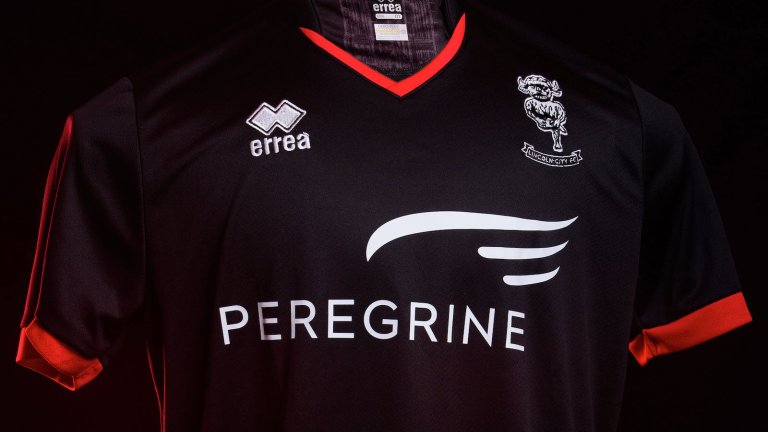 The Lincoln City 2020/21 black away kit, photographed on a mannequin against a black background.
