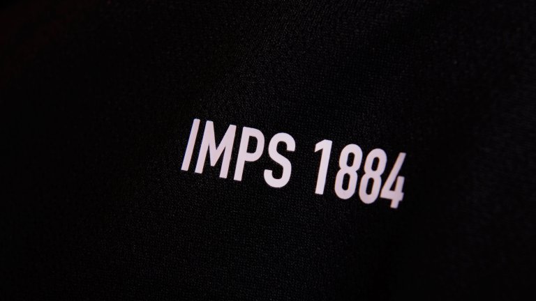 A close up of the words and letters 'Imps 1884' on the 2020/21 Lincoln City black away kit.