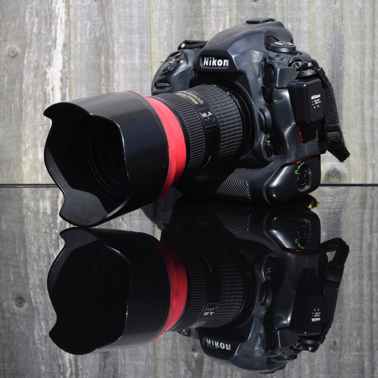 A photograph of a Nikon D5 sat on a reflective surface.