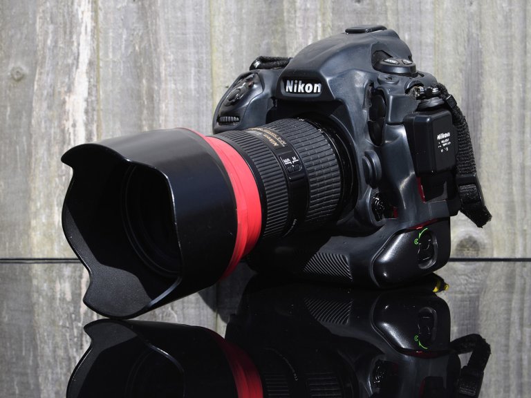 A photograph of a Nikon D5 sat on a reflective surface.