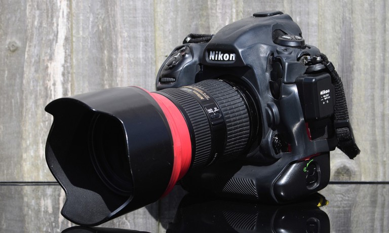 A photograph of a Nikon D5 sat on a reflective surface.
