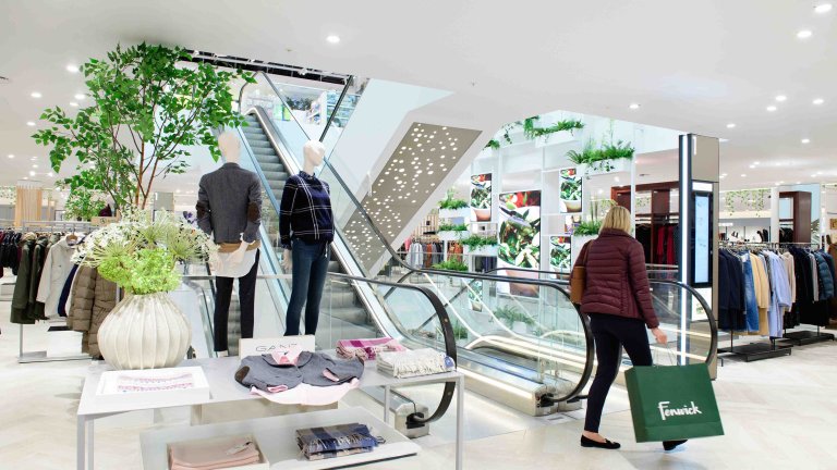 Chris Vaughan Photography - commercial photography | A woman uses an escalator in a department store.