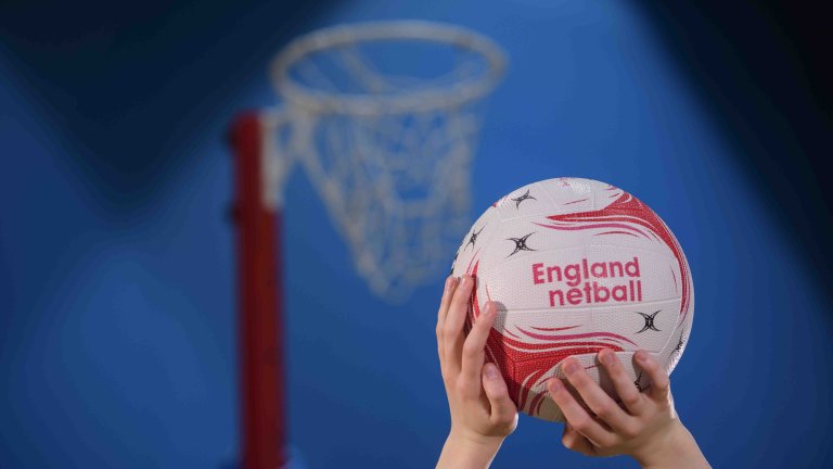 Chris Vaughan Photography - commercial photography | A close up of someone holding a netball with the words England Netball on the ball.