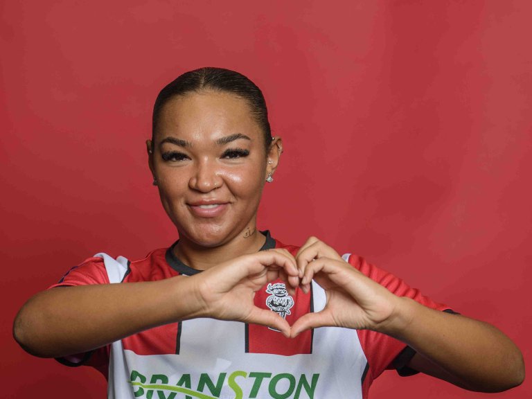 Chris Vaughan Photography - case study: Lincoln City | Lincoln City Women's Sinead Fletcher makes a love heart shape around the club badge.