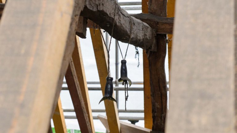 Old bottles hung from roof beams of the Old Kings Head.