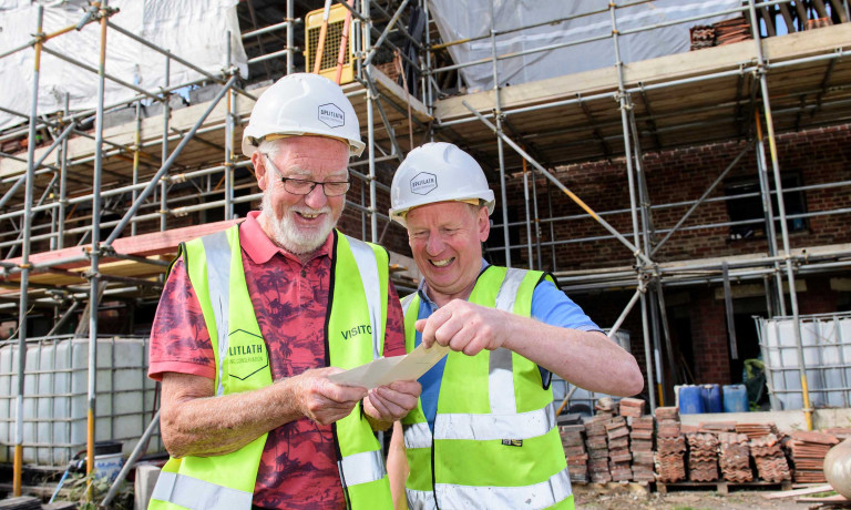 Former residents of the Old Kings Head look at old pictures.