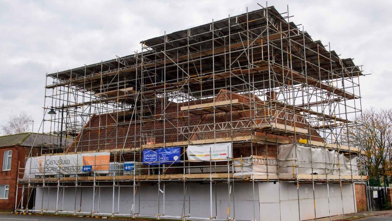 The Old Kings Head covered in scaffolding during renovation.