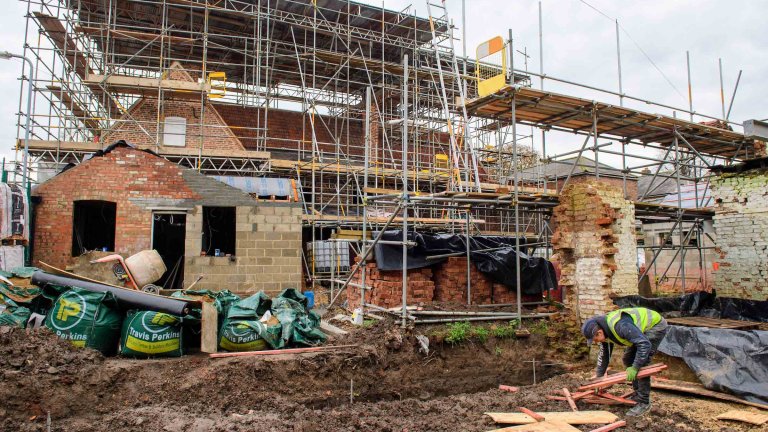A workman tidies up the site during renovation of the Old Kings Head.