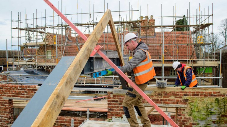 A worker on the roof of the Old Kings Head.