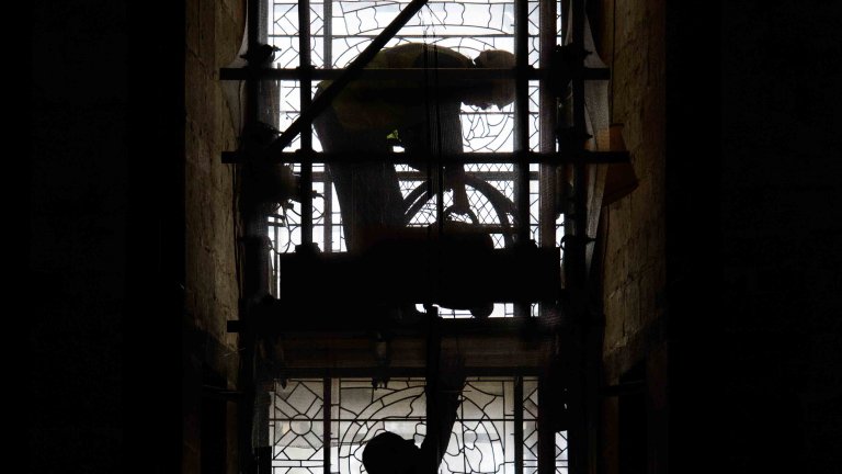 Chris Vaughan - case study images: Lincoln Cathedral | Two workmen silhouetted against a window.