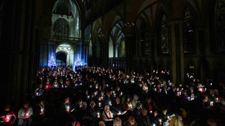 Chris Vaughan - case study images: Lincoln Cathedral | The congregation hold Christingles during a serivice.