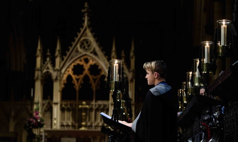 Chris Vaughan - case study images: Lincoln Cathedral | A choir member surrounded by candles during a service.