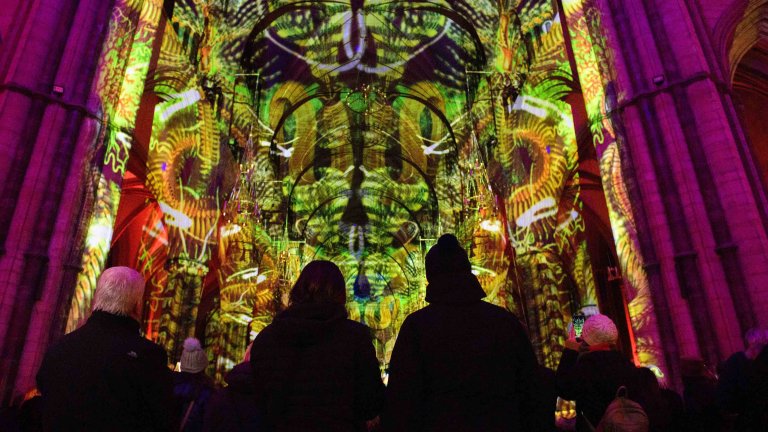 Chris Vaughan - case study images: Lincoln Cathedral | Members of the public look up at an art light installation inside Lincoln Cathedral.