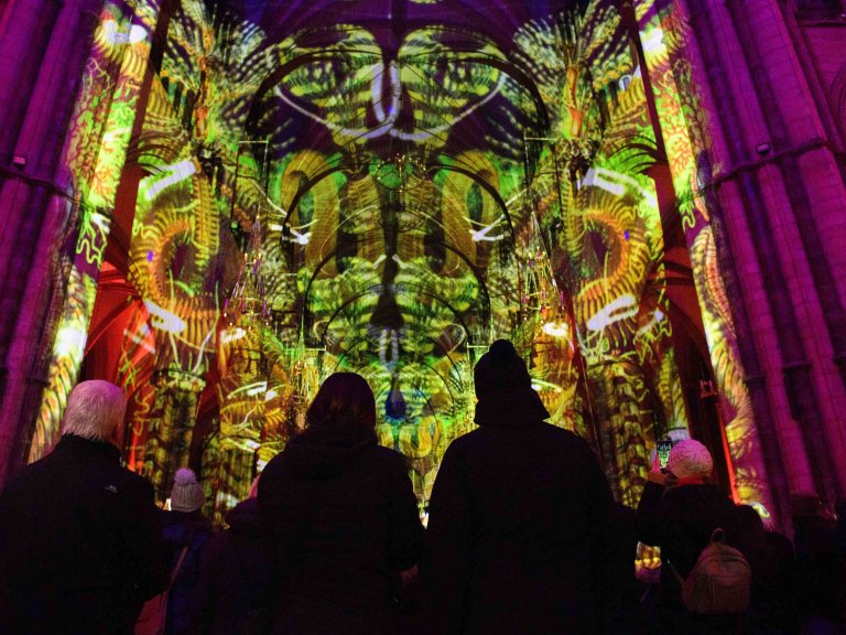 Chris Vaughan - case study images: Lincoln Cathedral | Members of the public look up at an art light installation inside Lincoln Cathedral.
