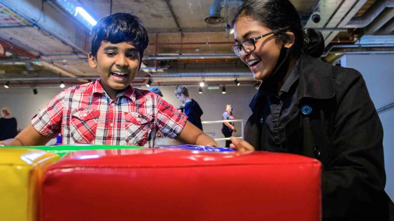 Chris Vaughan - case study images: MathsCity | Two young people attempt one of the challenges.