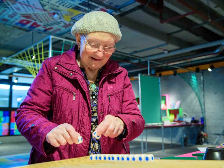Chris Vaughan - case study images: MathsCity | A lady attempts one of the tasks.
