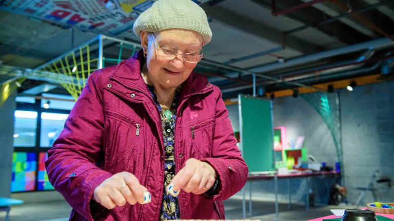 Chris Vaughan - case study images: MathsCity | A lady attempts one of the tasks.