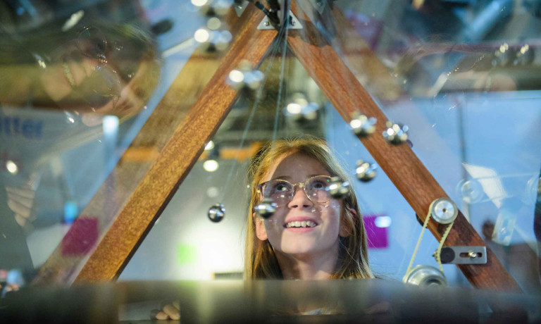 A person looks through an exhibit at MathsCity.