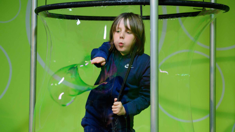 Chris Vaughan - case study images: MathsCity | A youngster bursts a bubble that has surrounded him.